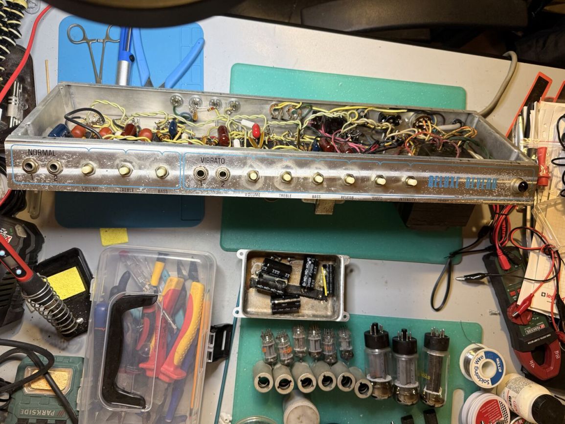 Faceplate removed from the cabinet, laid on the bench with tubes and the doghouse can nearby