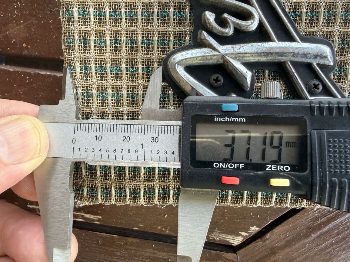 Digital calipers measuring the grille cloth panel width