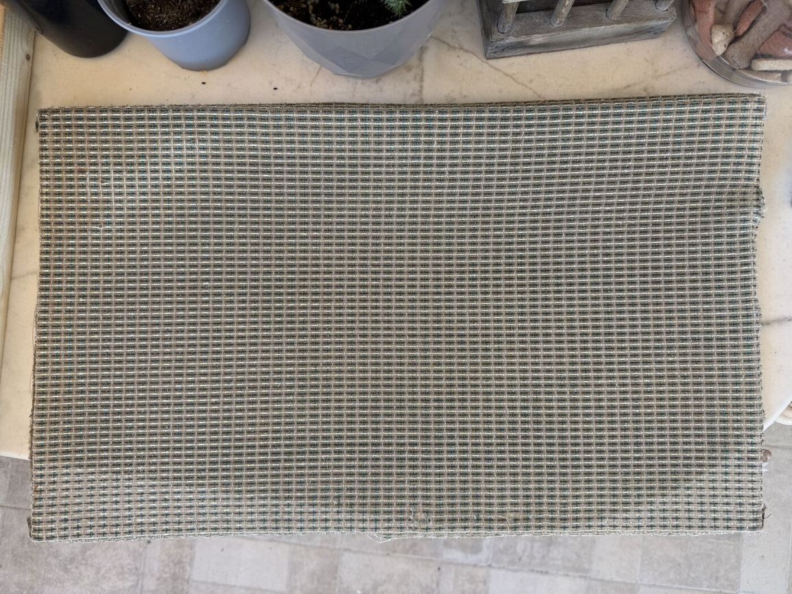 Original grille cloth laid flat after cleaning