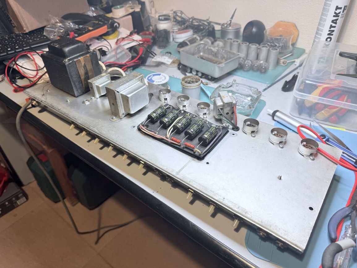 Full chassis pulled from the cabinet, laid out on the bench