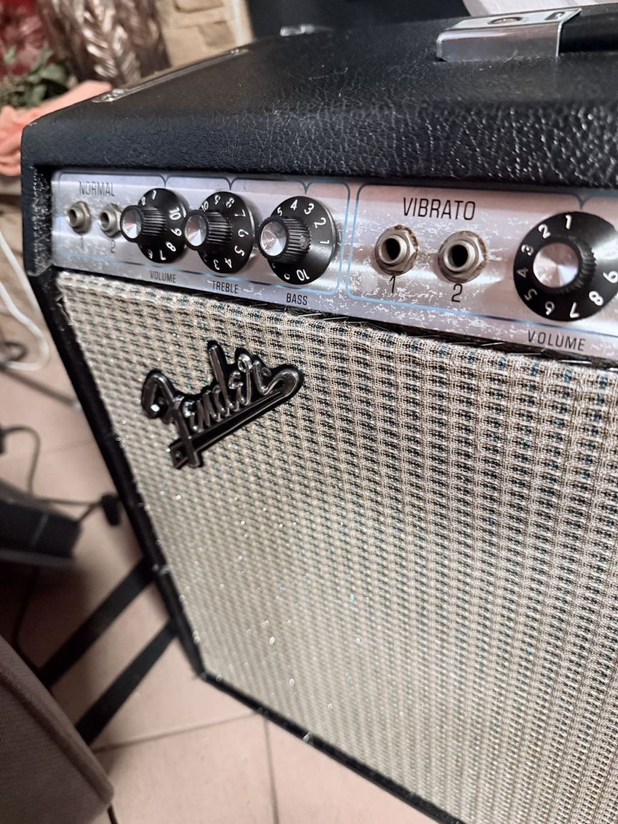 Close-up of the cleaned original grille cloth and reinstalled Fender badge