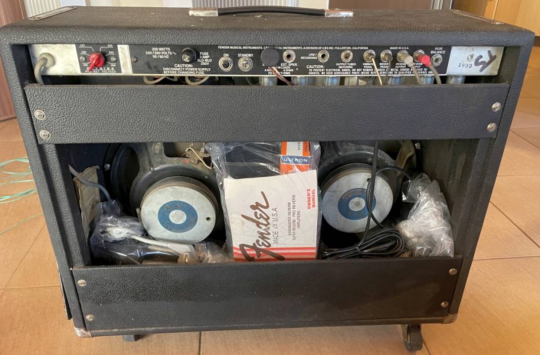 Back panel open showing the original speakers and factory owner's manual