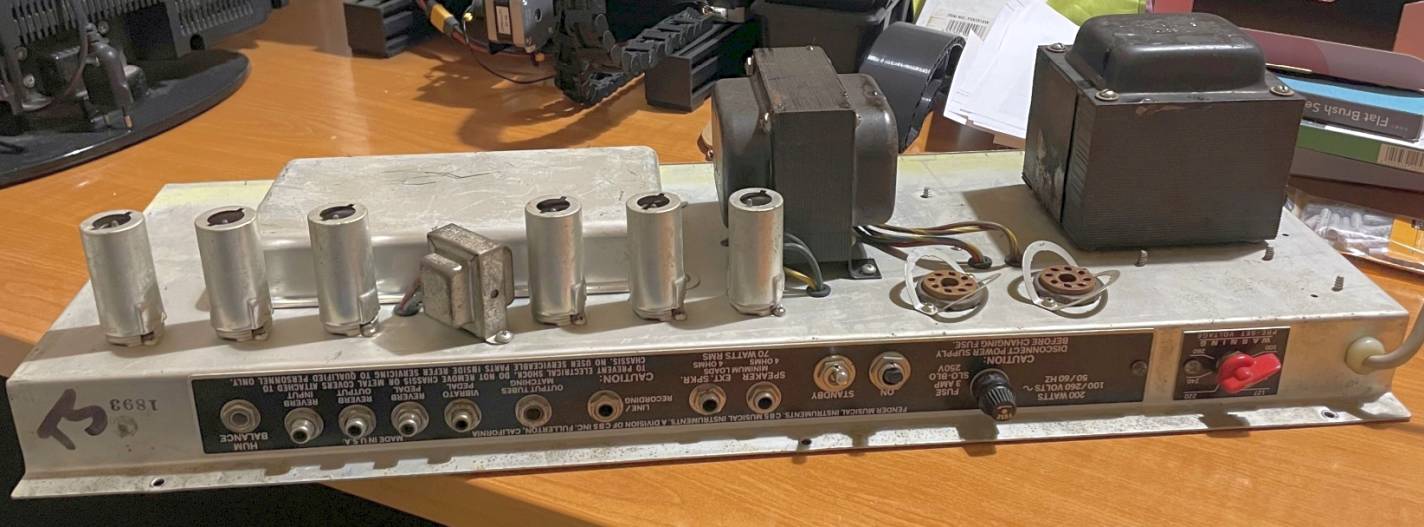 Chassis pulled from the cabinet, upside down on the bench